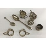 A collection of small silver wares to include four silver cup mounts, cream jug of helmet form,