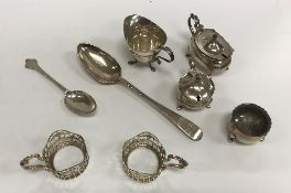 A collection of small silver wares to include four silver cup mounts, cream jug of helmet form,