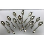 A collection of twelve early 19th Century silver "Old English" pattern dessert spoons,