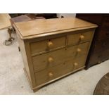 A Victorian pine chest of two short over two long drawers with turned knob handles raised on