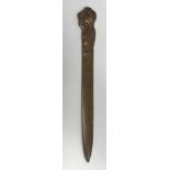 An Art Nouveau style brass paperknife, the handle as a naked woman with apple,