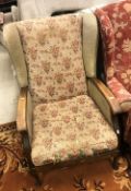 A circa 1930s wingback fireside chair, 95 cm high,