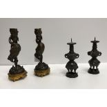 A pair of bronze and gilded candlesticks as cranes and fish, raised on a tripod base, 21 cm high,