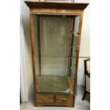 A modern ash veneered framed display cabinet the foreglass glazed top enclosing glass shelves and