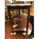 A mahogany occasional table of two circular tiers on turned supports,