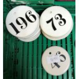 A collection of 20 various circular pottery and glazed black on white "Number" tags or labels