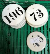 A collection of 20 various circular pottery and glazed black on white "Number" tags or labels