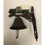 A modern painted cast metal wall bell with Landrover decoration