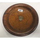 A turned oak dish bearing silver plated plaque to centre inscribed “Oak & Bell Metal of York