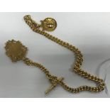 A silver gilt watch chain of graduated form set with two medallions and T bar,