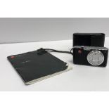 A Leica C-Lux I camera with leather case and instruction manual