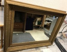 A circa 1900 gilt gesso rectangular swept framed wall mirror with plain plate 128 cm x 101 cm
