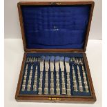 A set of twelve early 20th Century silver plated fish knives and forks,