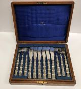 A set of twelve early 20th Century silver plated fish knives and forks,