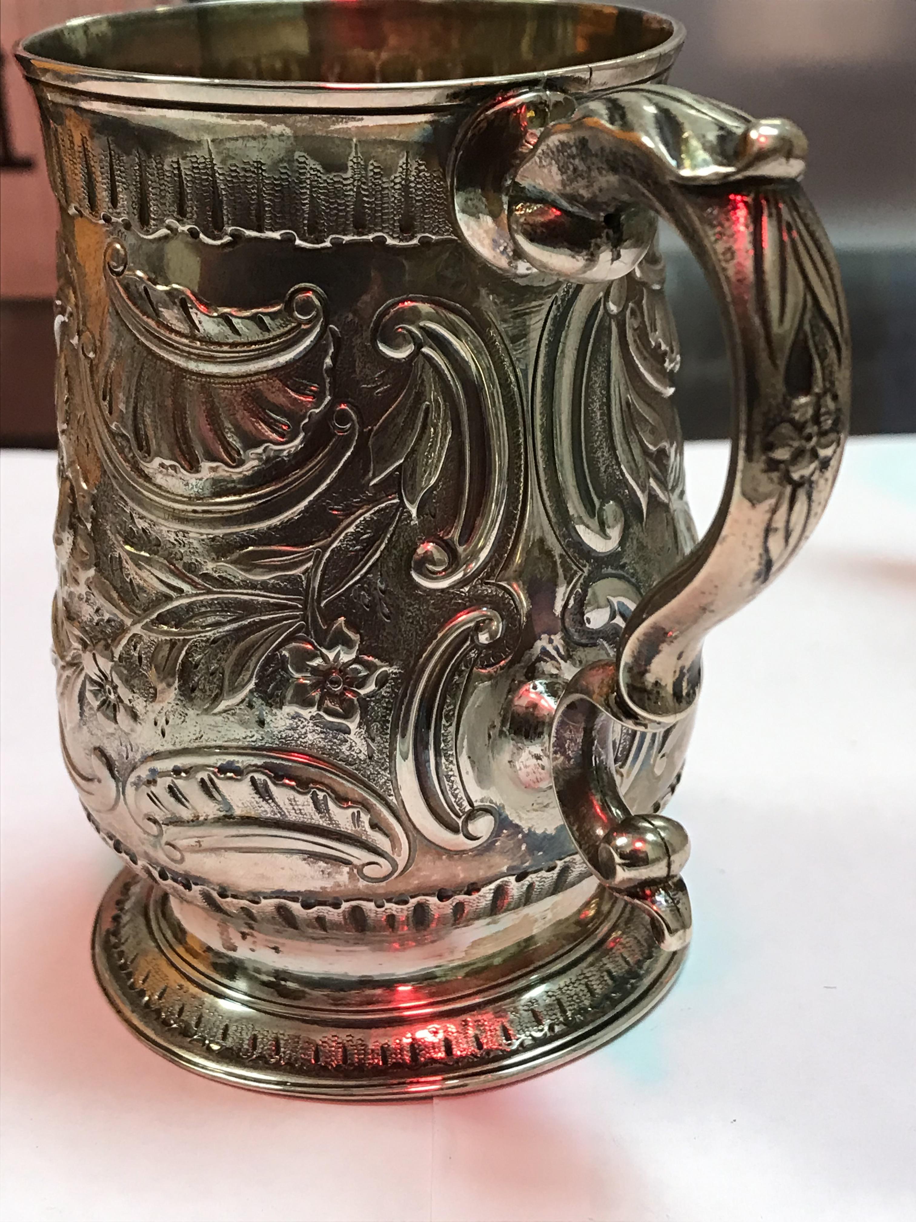 A George II silver baluster shaped mug with later foliate engraved decoration, - Image 9 of 42