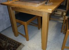 A modern light oak rectangular extending dining table on square supports (retailed be Lee Longland)