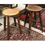 A Victorian beech circular stool on turned legs united by an X-stretcher together with a similar