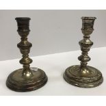 A pair of modern silver candlesticks in the 18th Century taste with turned type and ringed