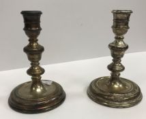 A pair of modern silver candlesticks in the 18th Century taste with turned type and ringed