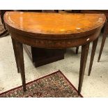 A pair of 19th Century saintwood card tables of demi lune form,