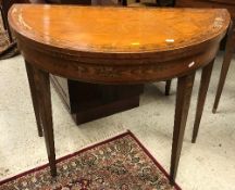 A pair of 19th Century saintwood card tables of demi lune form,