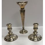 A pair of squat silver candlesticks with ringed decoration in the Georgian style (by William Comyns