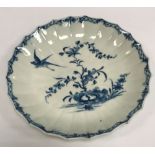 An 18th Century Worcester blue and white scallop shaped dish with bird alighting from exotic