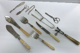 A small quantity of plated cutlery to include asparagus servers, bone handled anchovy tongs,