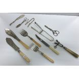 A small quantity of plated cutlery to include asparagus servers, bone handled anchovy tongs,