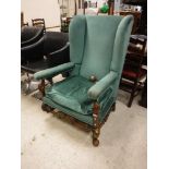 A circa 1900 upholstered wing back scroll armchair in the Flemish taste,