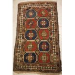 A Caucasian rug, the central panel set with repeating tiled decoration on a brown ground,