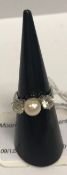 A white gold mounted (un-marked) pearl and white sapphire dress ring,