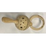 A carved ivory rattle teether inscribed "Estcourt from R.W. 1923.