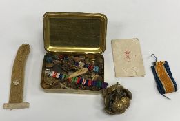 An embossed brass "Mary box", together with a collection of various military buttons and badges,