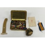 An embossed brass "Mary box", together with a collection of various military buttons and badges,