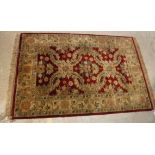 A Chobli rug, the central panel set with foliate decoration on a burgundy gorund,