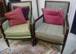 A set of three modern armchairs with stained show frames and coordinating upholstery