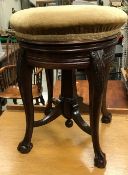 A Victorian mahogany circular adjustable piano stool by James Shoolbred,