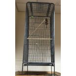 A modern tubular metal and wire framed bird cage 54cm square x 170 cm high