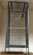 A modern tubular metal and wire framed bird cage 54cm square x 170 cm high