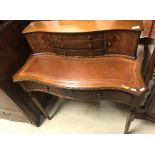 A modern mahogany bureau de dame with three drawer two door superstructure over two frieze drawers