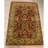 A Chobli rug, the central panel set with foliate decoration on a burgundy ground,