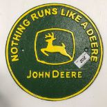 A modern painted cast iron sign inscribed "John Deere Nothing Runs Like a Deere",