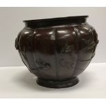 A Japanese Meiji period chocolate patinated bronze vase of squash form decorated in high relief
