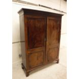 A late George III mahogany two door cupboard,
