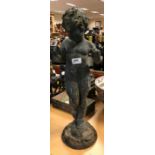 A cast lead figure of a putto stood upon a rock,