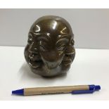 A modern bronze four faced Buddha head with character mark to base,