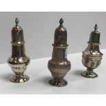A George III silver baluster shaped pepper with flaming torch finial and pierced domed cover,