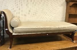 A modern chaise longue / day bed with stained show frame and cream upholstery,