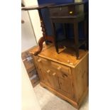 A modern pitch pine cabinet of two drawers above two cupboard doors,